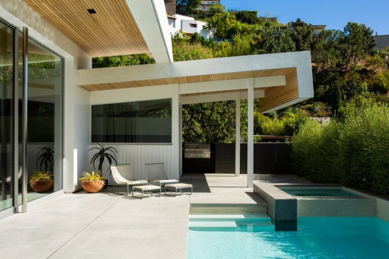 Open living space with a covered patio, pool, and X-Bond Microcement floors in a blade finish.